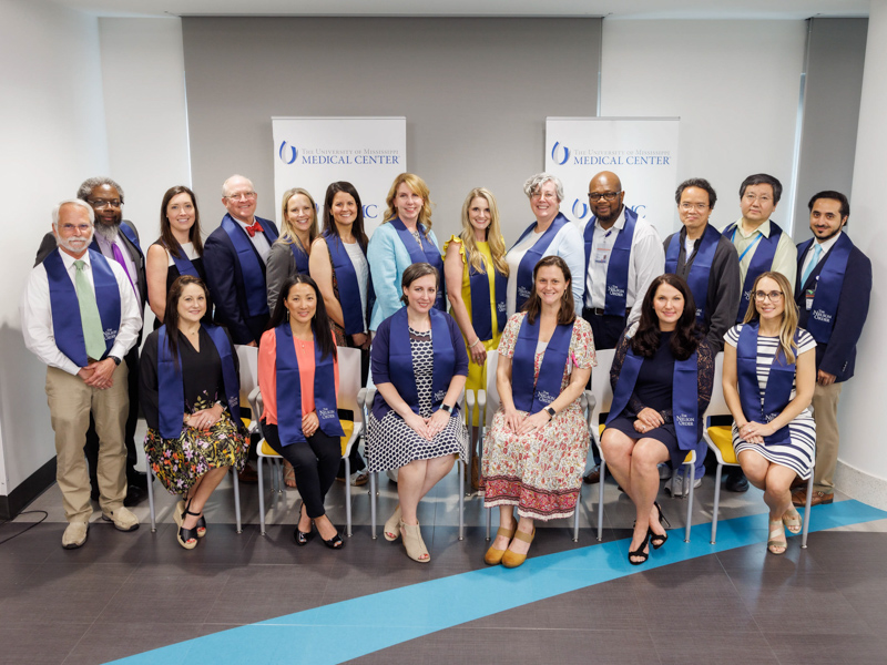 The 2022 Nelson Order Inductees are, seated from left: Dr. Kristy Cole (SHRP), Dr. Judy Gordy (SHRP), Dr. Asher Street (SHRP), Amanda McCullough (SON), Dr. Sue Phillips (SOM) and Dr. Courtney Davis (SOP); standing: Dr. David Brown (SGSHS), Dr. Stanley Smith (SOM), Dr. Austin Harrison (SOM), Dr. William Boteler (SOD), Dr. Amanda Morellato (SOD), Dr. Cynthia Senior (SOD), Dr. Neeli Kirkendall (SOD), Dr. Ellen Robertson (SOM), Dr. Audwin Fletcher (SON), Dr. Yuefeng Lu (SOD), Dr. Yufeng Zheng (SOPH) and Dr. Osman Athar (SOM) Not Pictured: Dr. Kandy Smith (SON) Joe Ellis/ UMMC Communications 