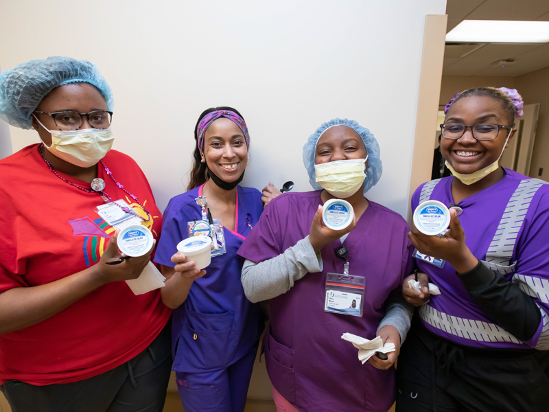 From left, pharmacy technicians Tiana Hathorn, Chiquita Campbell, Tierra Mozee and Terri Irving are all smiles after getting an ice cream happy from senior hospital leaders as part of Employee Appreciation Week. Melanie Thortis/ UMMC Communications 