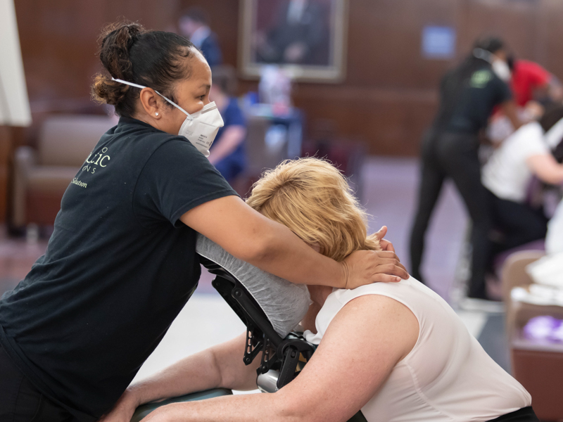 Massage therapist Nina Tieu with Therapeutic Connection massages School of Medicine education administrator Cindy Chesteen as part of Employee Appreciation Week. Melanie Thortis/ UMMC Communications 