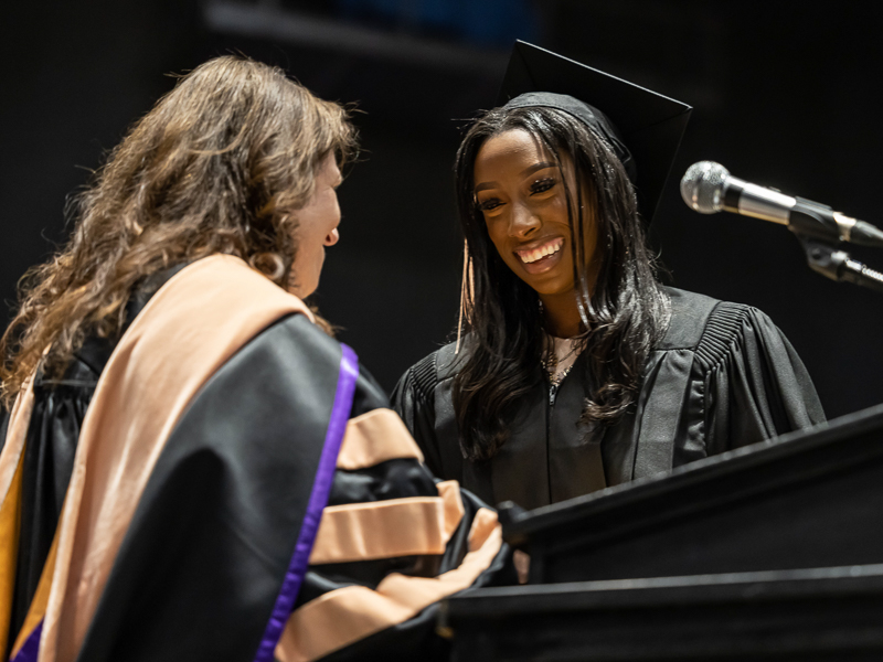 School of Nursing graduate Yashmen Evans is given the Richard N. Graves award by School of Nursing Dean Dr. Julie Sanford.