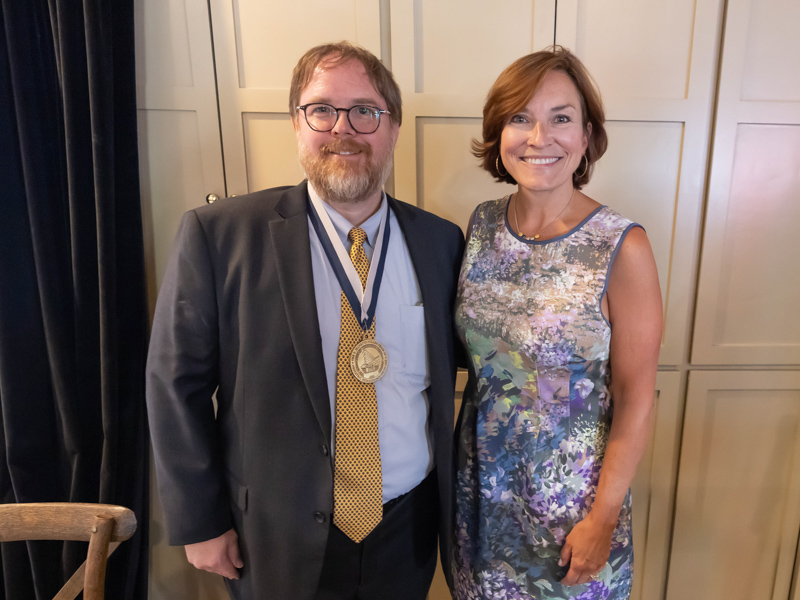 Collier, wearing the medal of the D. Jeanette Pullen Chair of Pediatric Hematology-Oncology, is congratulated by Dr. Mary Taylor, Suzan B. Thames Chair and professor of pediatrics. Melanie Thortis/ UMMC Communications 