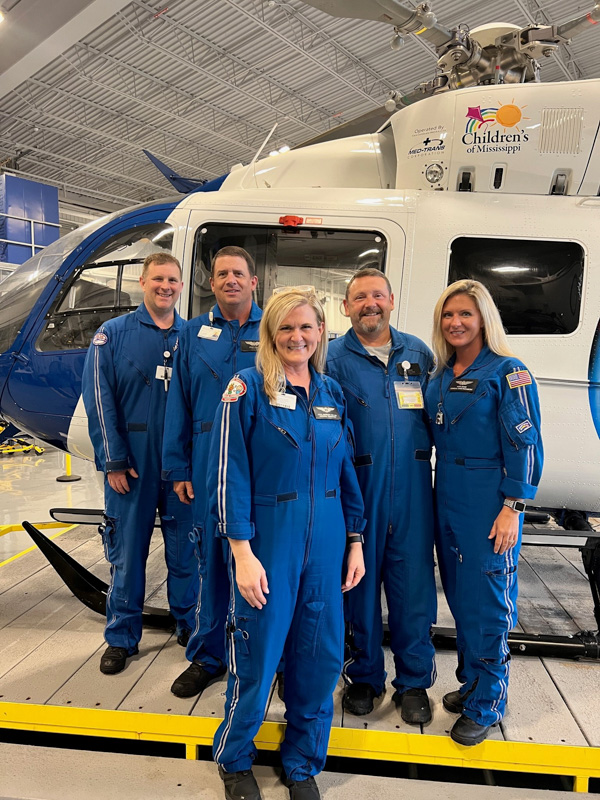 AirCare crew members gathered in the hangar at the Mississippi Center for Emergency Services are, from left, Kevin King and Stacy Gill; center, April Davidson, who recently retired after transporting and caring for newborns with AirCare since 2008; Bo Sullivan; and Kaci David, Sullivan's flight partner.