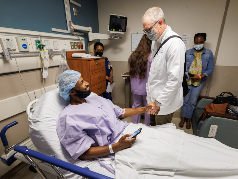 Dr. Christopher Anderson, professor and James D. Hardy Chair of the Department of Surgery, checks in with Quinten Hogan before they go to the OR. Anderson removed Hogan's left kidney for implantation into Hogan's mom, Tawanna Davis. Joe Ellis/ UMMC Communications