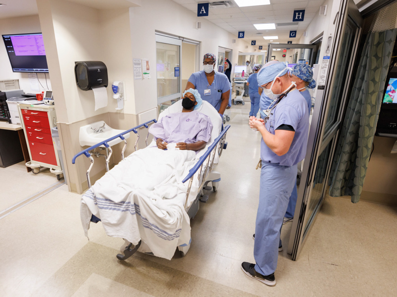 Quinten Hogan leaves a holding area to be rolled into surgery to remove his left kidney for transplantation into his mom, Tawanna Davis.