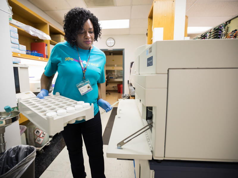 Cytotechnician Diane Catchings processes patient's Pap test samples. Joe Ellis/ UMMC Communications 