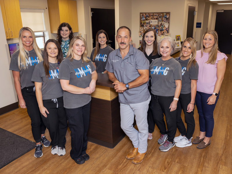 Staff members and current trainees at UMMC-Dermatology Louisville are, front row, from left: Shalon Woods, customer care representative; Haley Eaves, RN; Julie Hunter, RN, and care coordinator; Dr. Adam Byrd; Vicki Morgan, LPN; Laura Beth Fulton, LPN; and Rachel Wilkinson, fourth-year medical student; back row, from left: Erin Sears, third-year medical student; Amber Yates, customer care representative; and Dr. Sarah McClees, fourth-year dermatology resident. Jay Ferchaud/ UMMC Communications
