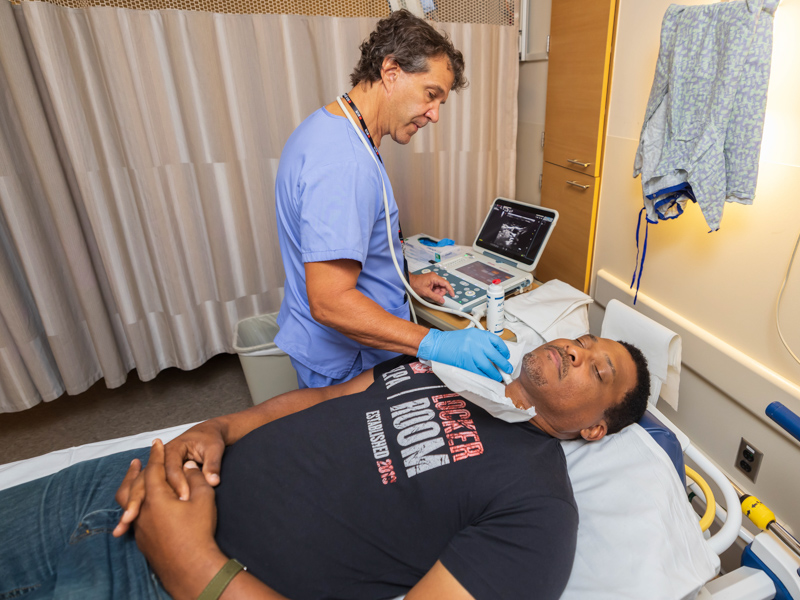 Living Heart Foundation ultrasound technician Ken Grosse performs an carotid artery ultrasound on former NFL player Andre Collins, executive director of the Professional Athletes Foundation at the NFL Players Association. Melanie Thortis/ UMMC Communications 