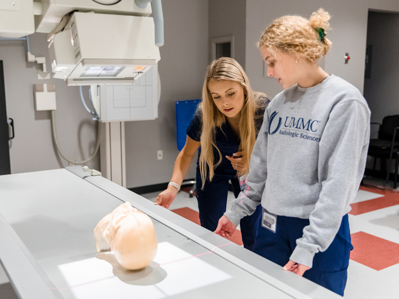 Radiologic Sciences students Kaleigh Wilding and Jordan Pritchard move and set up x-ray equipment during a skills lab.