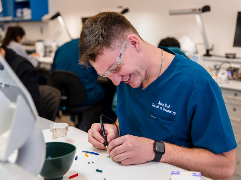 First-year School of Dentistry student Alex Rial fashions a knight and a sea monster from heated wax using inspiration from the fantasy drama Game of Thrones.