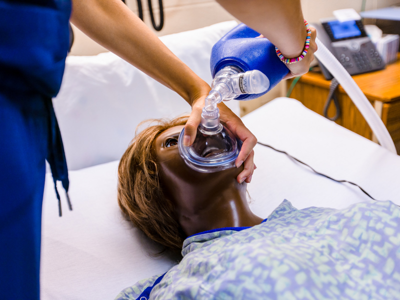 Abigail Lynn helps perform CPR on a manikin during a skills relay at the School of Nursing.