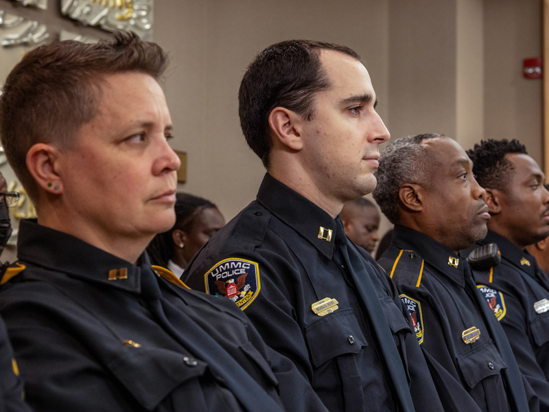 Capt. Jennifer Krump, director of public safety support services; Capt. Nicholas Kehoe; Capt. William Waples, Sgt. Antione Golden, Sgt. Shaun Hiley and Officer Garry Lee listen to speakers at the Blessing of the Badges. Jay Ferchaud/ UMMC Communications