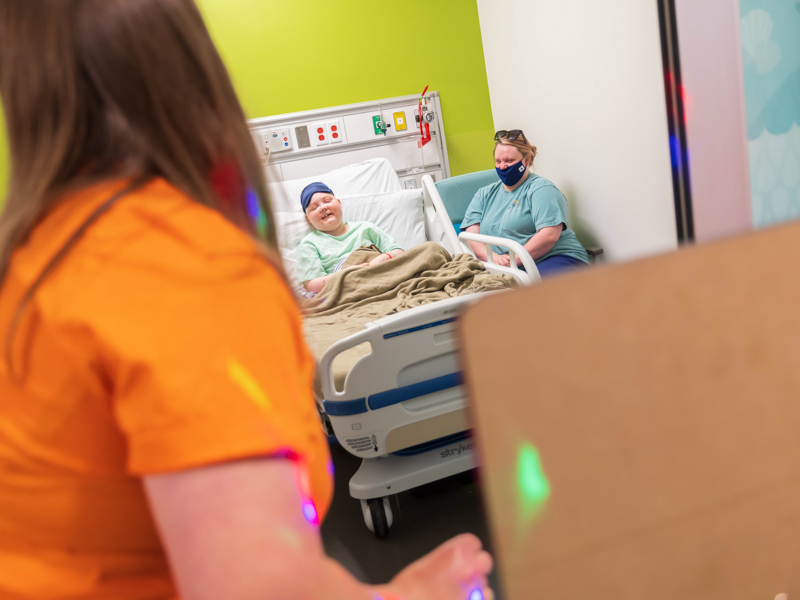 Children's of Mississippi patient Jett Bufkin and his mom, Amber Bufkin of Richton, smile during a reverse trick-or-treating visit Friday. Melanie Thortis/ UMMC Communications 