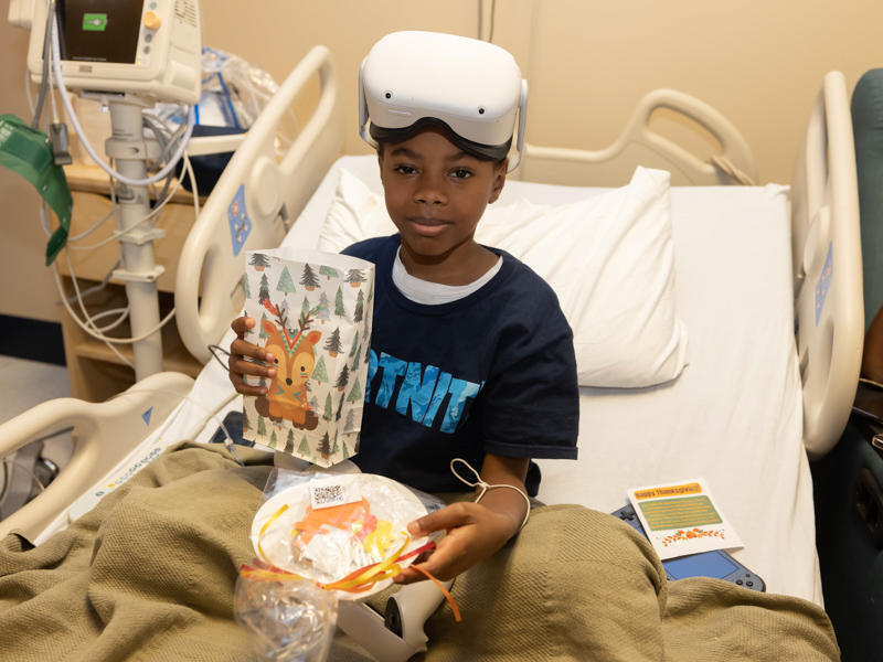 Children's of Mississippi patient Kaiden Hunter of Laurel holds his holiday treats from a Thanksgiving Parade that rolled through the halls of the state's only children's hospital. Melanie Thortis/ UMMC Communications 