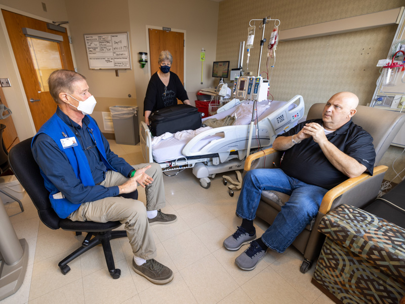 BMT volunteer and transplant recipient Cliff Russell draws on his own experiences to give BMT patient Scott Brumfield tips for recovery and living infection-free.Jay Ferchaud/ UMMC Communications