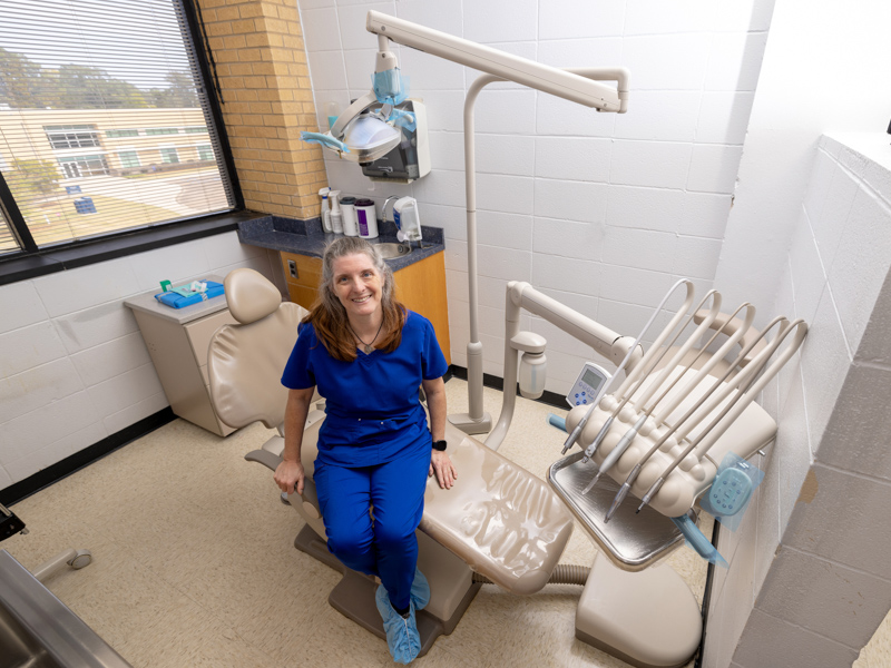 Christy Logan, a 1991 graduate in the dental hygiene program at the School for Health Related Professions, today works as a dental hygienist at the School of Dentistry. Jay Ferchaud/ UMMC Communications 