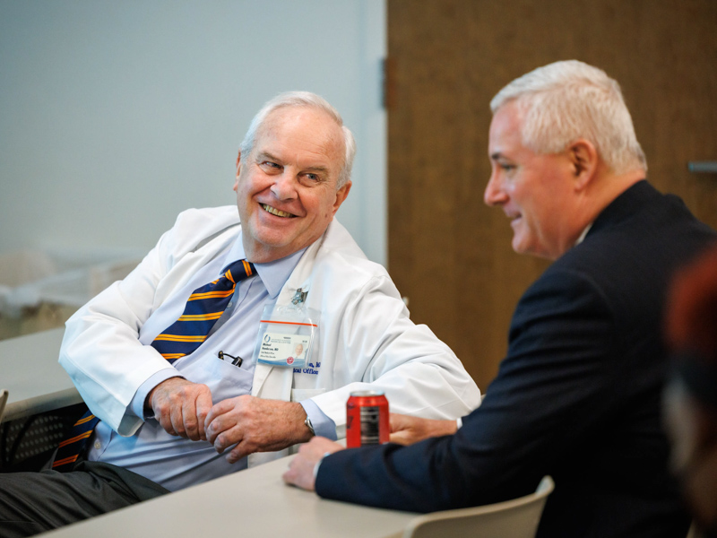 Dr. Michael Henderson chats with Adult Hospitals Chief Executive Officer Britt Crewse. Joe Ellis/ UMMC Communications