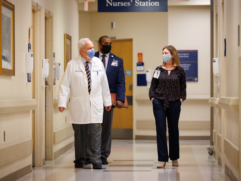From left, Chief Medical Officer Dr. Michael Henderson, SHRP Assistant Dean for Academic Affairs Dr. Driscoll DeVaul and Office of Patient Experience Director Skye Stoker walk a patient floor as part of Leadership Rounds. Joe Ellis/ UMMC Communications
