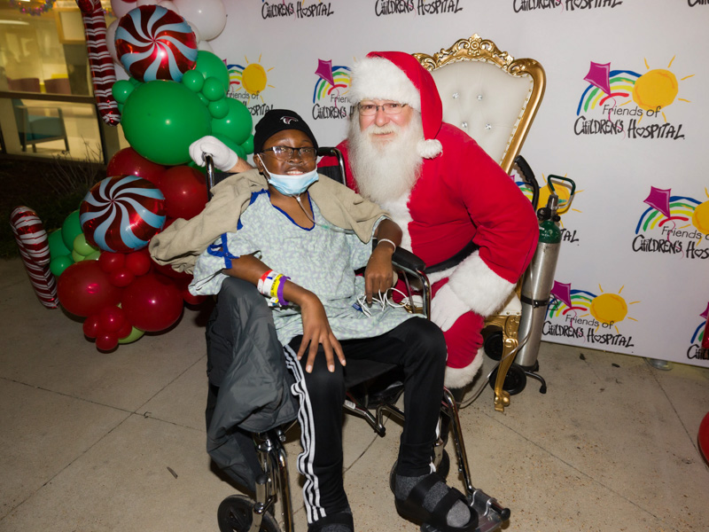 Children's of Mississippi patient David Thomas of Leland smiles during a visit with Santa at BankPlus Presents Light-A-Light. Joe Ellis/ UMMC Communications
