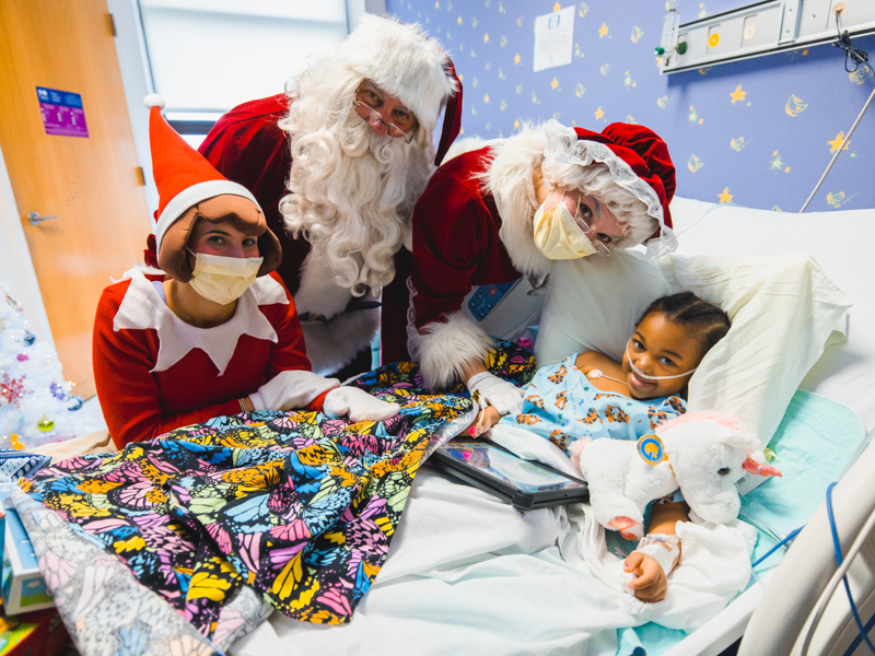 The Claus family poses with Children's of Mississippi patient Jamarla Brazzle of Cruger during their visit to the children's hospital. Lindsay McMurtray/ UMMC Communications 