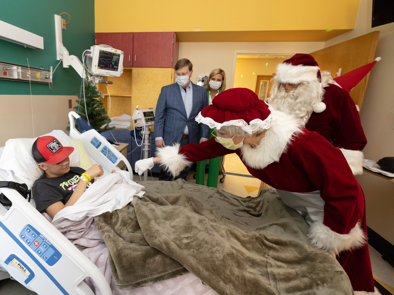 Children's of Mississippi patient Cooper Brady of Columbia and Mrs. Claus fist bump during a visit with Santa Claus, Gov. Tate Reeves and First Lady of Mississippi Elee Reeves. Jay Ferchaud/ UMMC Communications 