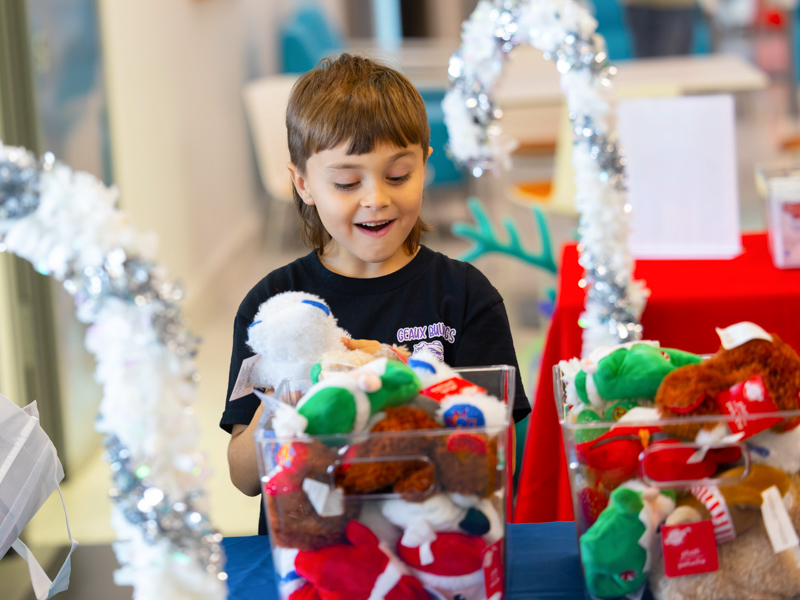 Children's of Mississippi patient Branson Canley of Mount Olive smiles while choosing holiday treats from Friends of Children's Hospital for his Christmas stocking. Melanie Thortis/ UMMC Communications