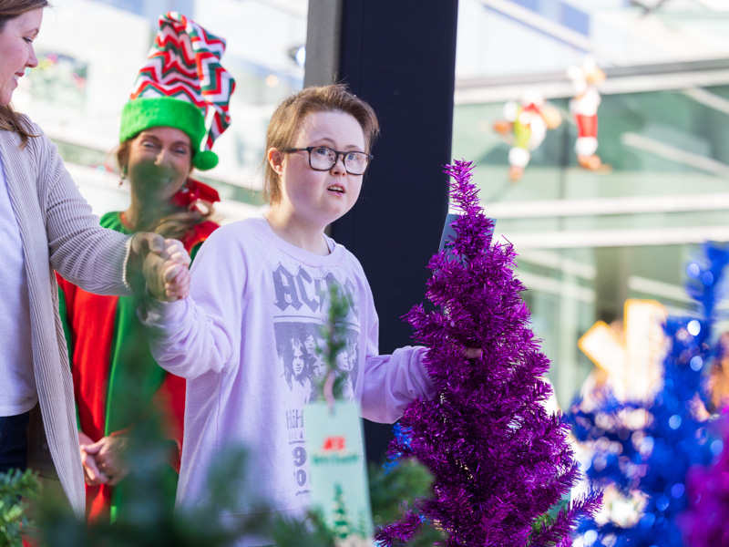 Children's of Mississippi patient Katie Moore of Marion enjoys a wintry tree farm scene during BankPlus Presents Winter Wonderland. Melanie Thortis/ UMMC Communications 