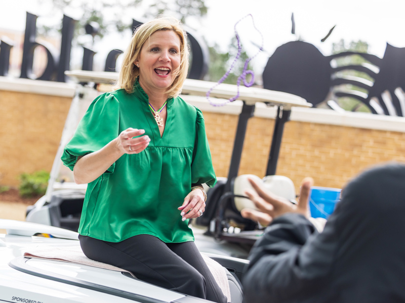 First Lady of Mississippi Elee Reeves throws beads to Children's of Mississippi patients during the Mississippi Department of Public Safety Mardi Gras parade Tuesday. Melanie Thortis/ UMMC Communications 