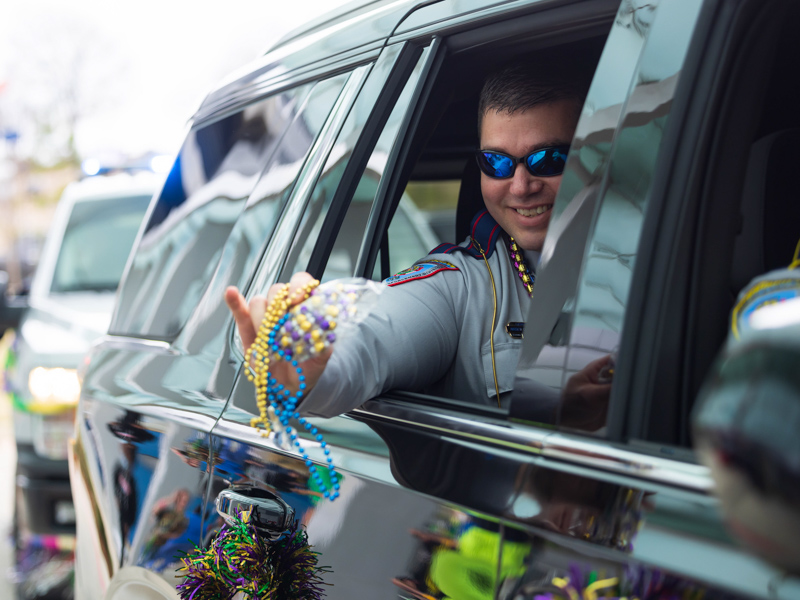 Mississippi Highway Patrol officers were among those throwing Mardi Gras beads to Children's of Mississippi patients during the Mississippi Department of Public Safety parade Tuesday. Melanie Thortis/ UMMC Communications 