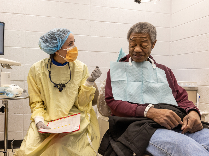 Dental student Kara Cook talks all things dental with Dwight Hollman during Dental Mission Week.