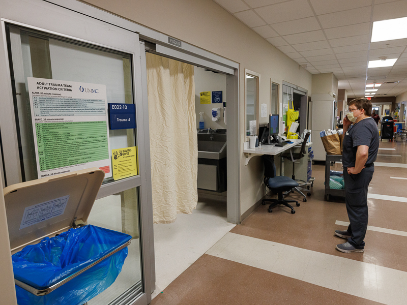 Registered nurse Adrian Davis stands outside a trauma room in the Adult Emergency Department at the University of Mississippi Medical Center.