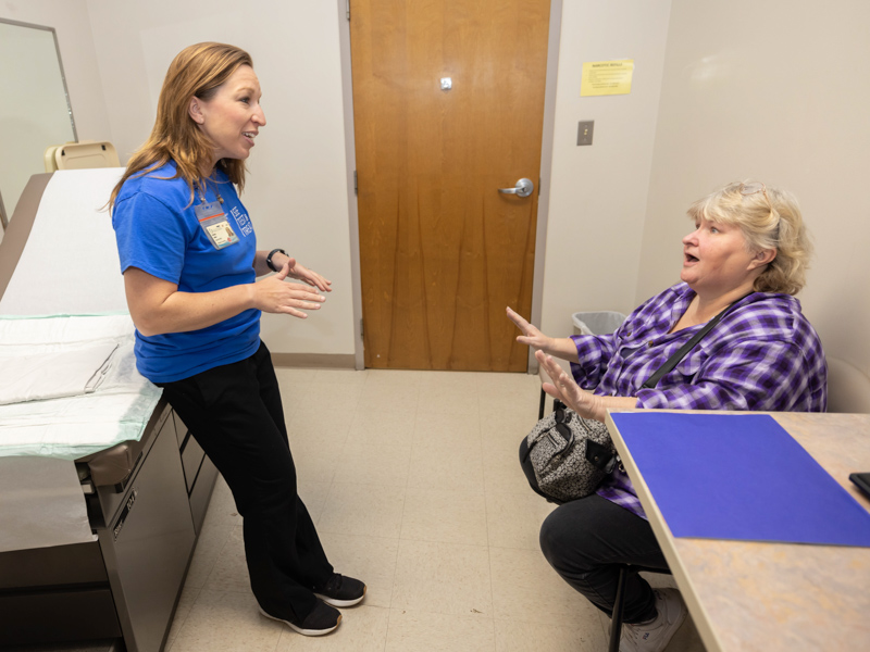 Bethany Sabins, a nurse practitioner, talks with D'avy during the event.