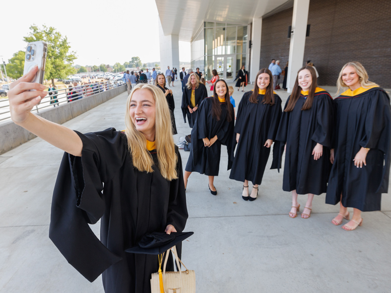 Cara Irby handles the camera duties as Master of Biomedical Sciences graduates, from left, Isabelle Garza, Hayden Tucker, Emma Grace Joyner and Kaleigh Thomas take a pre-graduation selfie.