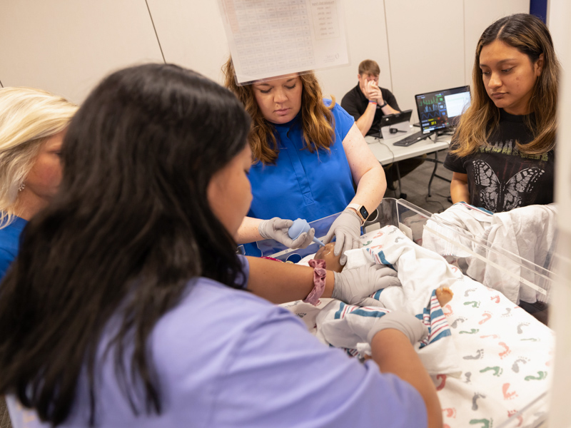 From left, Lifecare EMS paramedic Mayra Sanchez, Baptist Hospital Jackson ER nurse Merrell Hourguettes and Mirzait Sanchez, a recent East Central Community College nurse graduate go through the steps of resuscitating a newborn baby.