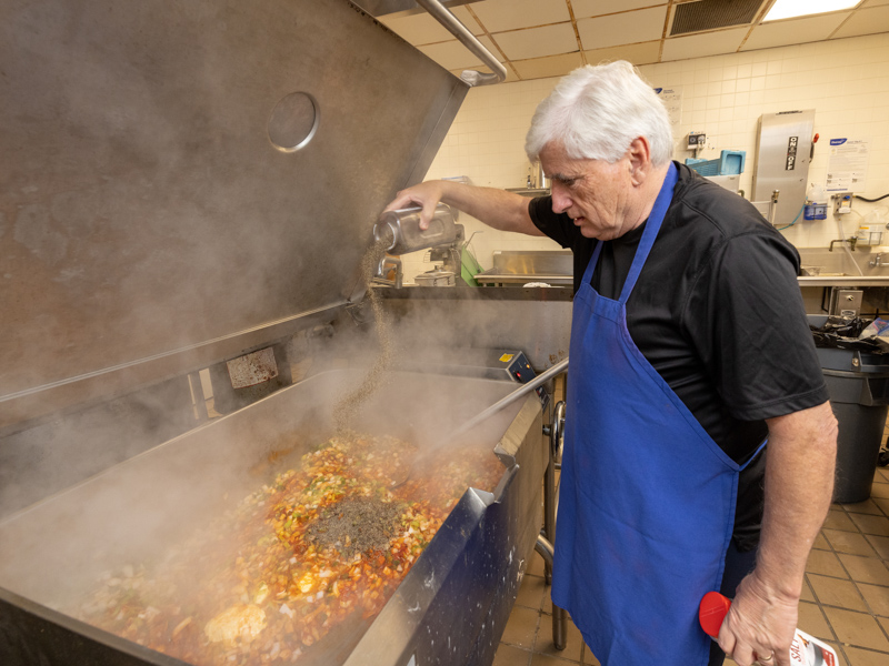 Granger adds his special seasonings to a dish for the annual SGSHS open house last November, his way of saying “thank you” to supporters. Jay Ferchaud/ UMMC Communications 