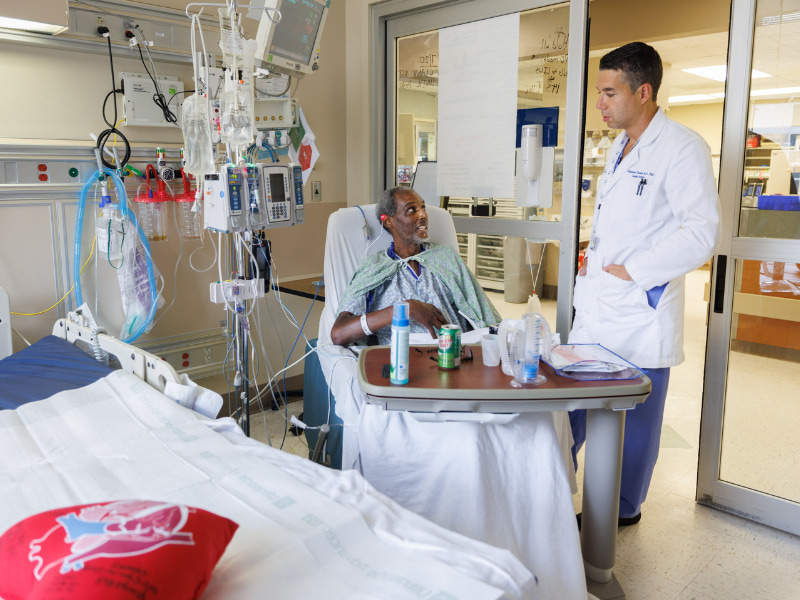 Dr. Athanasios Tsiouris, assistant professor of cardiothoracic surgery, talk with with transplant patient Ricky Mayers.