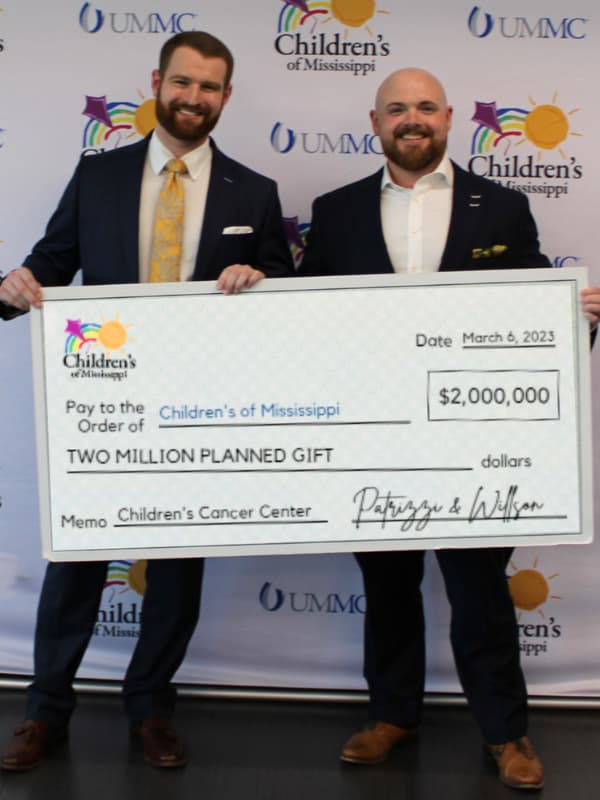 Gates P. Willson, left, and Chase Patrizzi of Patrizzi & Willson Financial Group show their $2 million planned gift to Children's of Mississippi.