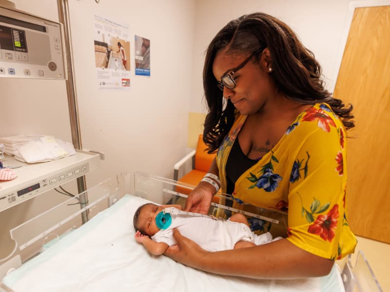 Takia Hampton of Jackson smiles at her newborn daughter, Isabella.