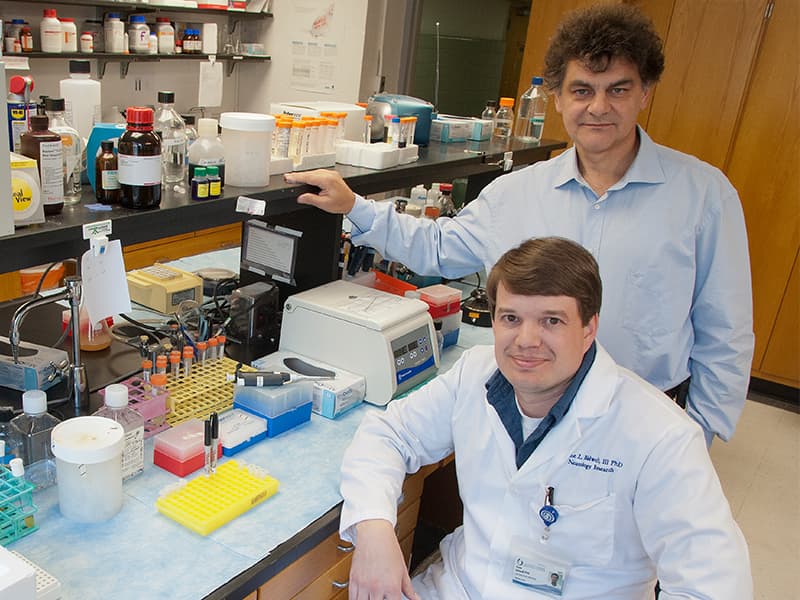 In this 2017 file photo, Bidwell sits with his doctoral mentor Dr. Drazen Raucher after they received a patent on a process that potentially can halt cancer metastasis.
