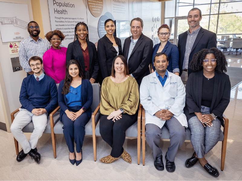 Gamble, sitting in center, with members of the Mississippi Diabetes Project, a $5 million grant funded by the CDC. The Mississippi Diabetes Project team includes, standing, left to right: Thomas Mayfield, Jayda Lee, Juaqula Madkin, Dr. Victoria Gholar, Gregrey Hall, Dr. Izzy Thornton, Kyle Brewer and sitting: Brian Christman, Aurora Diaz, Dr. Abigail Gamble, Dr. Vishnu Garla, Haley Bender James.