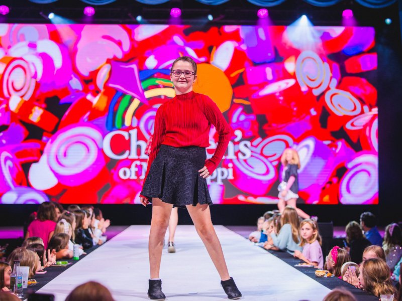 Madison McCullough wears a red sweater and skirt perfect for Christmas gatherings.