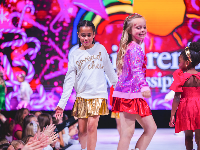 Katie Rose Guilfoyle wears a golden skirt with matching sweatshirt.