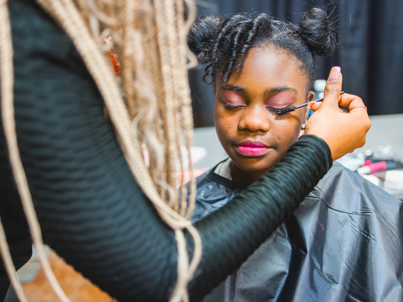 Nolee Jones gets a touch of mascara before modeling.