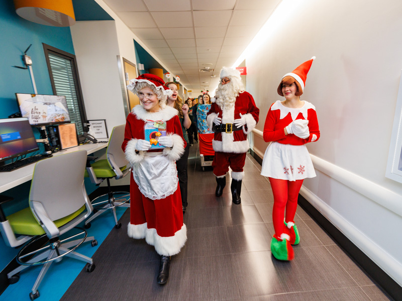 Mrs. Claus, the Elf on the Shelf and St. Nicholas paid a visit to the neonatal intensive care unit at Children's of Mississippi, leaving babies toys as a holiday surprise. Jay Ferchaud/ UMMC Photography
