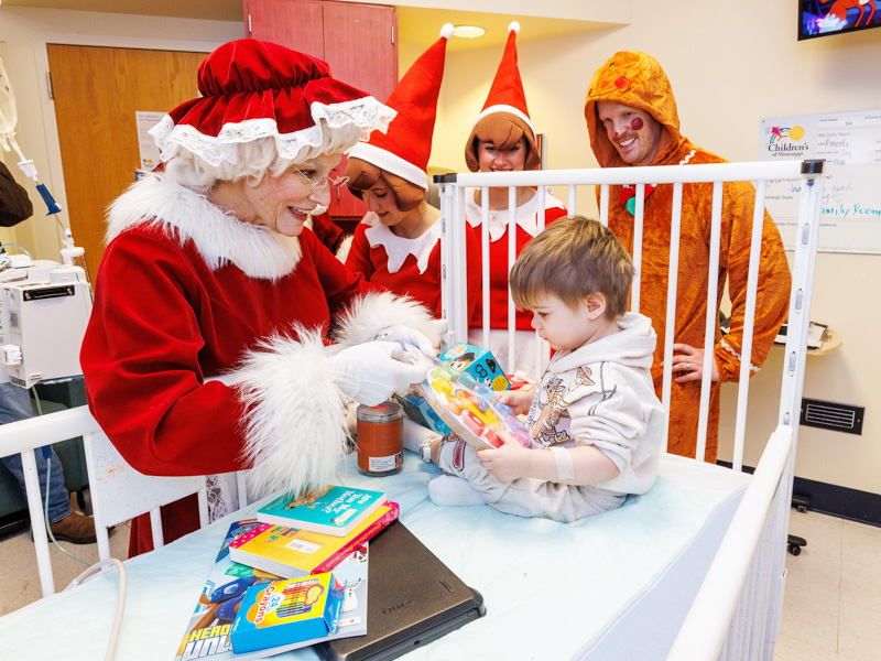 Children's of Mississippi patient Jacob Warren of Meridian plays with a puzzle during a visit with Mrs. Claus, Elves on the Shelf and a gingerbread man. Jay Ferchaud/ UMMC Photography 