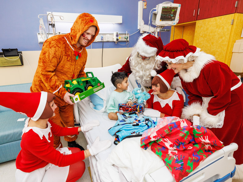 Children's of Mississippi patient Amaziah Edwards of Philadelphia greeted his visitors from the North Pole by saying, "Come on in, Christmas!" Jay Ferchaud/ UMMC Photography