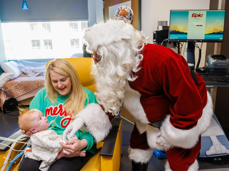 Sieger Sims of Madison, held by mom Meredith, gets his first visit from Santa at Children's of Mississippi. Jay Ferchaud/ UMMC Photography