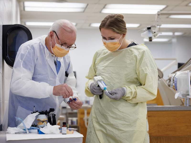 Dr. Darrell Hutto and D3 Shelby Fortenberry work together on finishing an impression for a denture.
