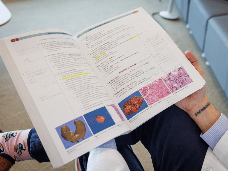 As Thomas Moore reads over one of his medical textbooks, his tattoo -- "Feb. 4, 2019," inscribed in Roman numerals -- is clearly visible.