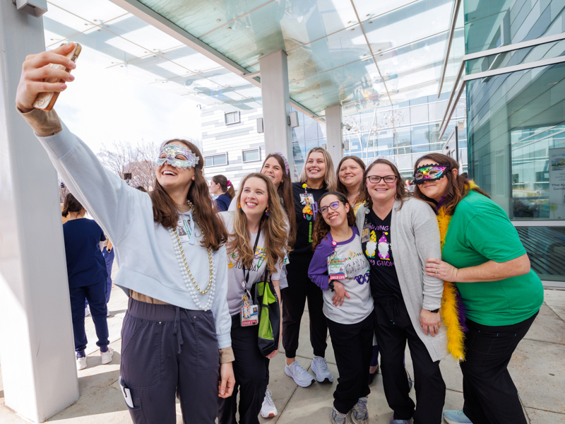 Child life team members at Children's of Mississippi smile for a selfie taken by Sophie Patikas, an child life student at Auburn University.