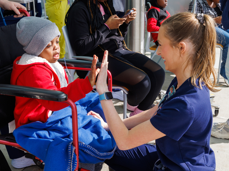 School of Nursing student Hannah Rae Britt gets an high five from Children's of Mississippi patient Kieon Jones of Vicksburg.